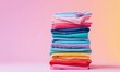 © piai - Neat Stack of Freshly Folded Colorful Clothes in Vibrant Colors