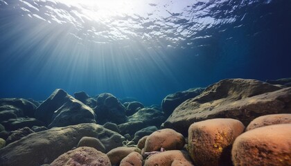 Poster - dark blue water of a deep ocean with sun rays reaching the rocky seabed beautiful underwater landscape