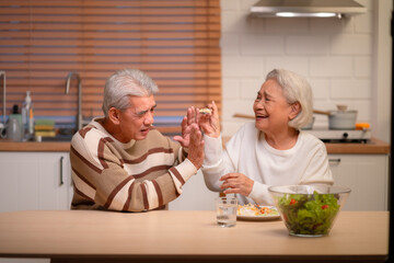 Wall Mural - Senior Love and Healthy Living: Elderly Couple Shares Care and Happiness Together in Retirement, Lifestyle Filled with Family, Healthy Food, and Joyful Meals, Smiling Grandparents Nurturing