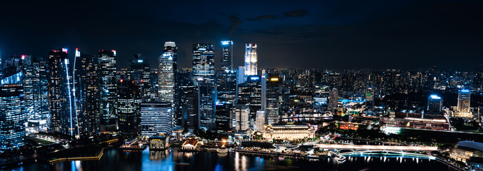 Wall Mural - Singapore's Dazzling Night Skyline: Modern Architecture and Skyscrapers Illuminate the Cityscape, A Spectacular View of Marina Bay's Famous Business District and Urban Landmarks by Water at Twilight