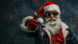 © sornram - Cool Santa Claus wearing sunglasses and a leather jacket gives a thumbs-up gesture, capturing the festive holiday spirit with a modern twist.