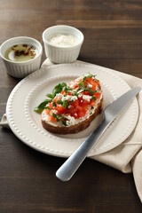 Wall Mural - A sandwich in a plate on a dark wooden table.