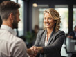 © shrinay - Happy mid aged business woman manager handshaking at office