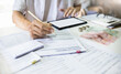 © Lek - Asian man review business loan application and checking bank statement online via tablet before apply for loan approval to start new business