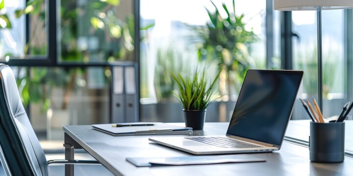Modern Office Workspace with Laptop and Green Plants