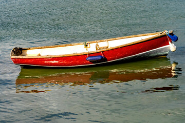 Wall Mural - Colorful Red Rowboat Water Reflection Abstract Harbor Dartmouth Devon England