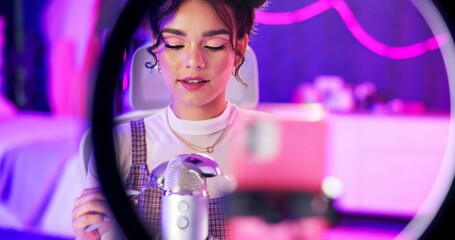 Fototapete - ASMR, relax and influencer woman with microphone, ring light and audio content creator in neon home studio. Streamer, girl and recording video for sound art platform, live stream or online broadcast