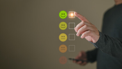 a businessman choose the virtual screen on the happy smile face icon to give satisfaction in service.rating very impressed.customer review service and Satisfaction concept