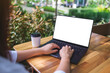 © Farknot Architect - Mockup image of a woman using and typing on laptop computer with blank white desktop screen in the outdoors