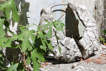 Poster - A stone sculpture sits beside a wall, offering a contemplative moment.