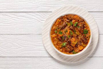 Sticker - beef barley soup in a bowl, top view