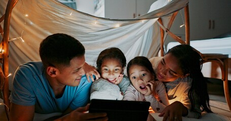 Canvas Print - Night, reading and tablet with family in bedroom of home together for bonding, love or storytelling. Education, learning or wow with mother, father and kids on bed in apartment for child development