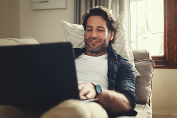 Sticker - Laptop, smile and man in home for remote work, reading email and social media. Computer, relax and freelance journalist in living room for writing article, research report or news on internet on sofa