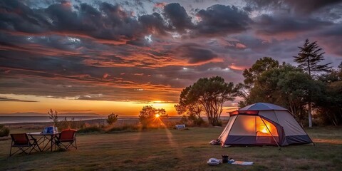 Sticker - Tranquil camping scene at dusk with a glowing sunset in the background, camping, nature, outdoor, tent, adventure, wilderness