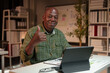 © crizzystudio - Happy African American man looking at laptop computer screen, typing, searching for information, checking email, chatting on social network. Freelance blogger working on online projects.