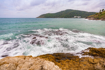 Wall Mural - .Around the island there are large rocks surrounding it. When a big wave hits, the water splashes and bursts into tall foam, looking beautiful and frightening. sandbars connect to the island...
