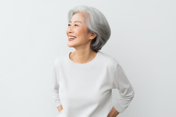 Wall Mural - portrait of a happy asian mature woman looking away indoor