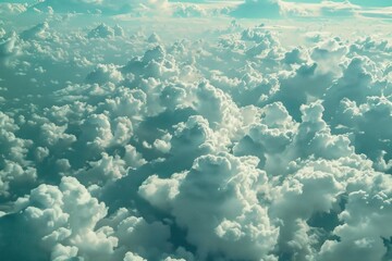 Aerial view of fluffy white clouds covering blue sky