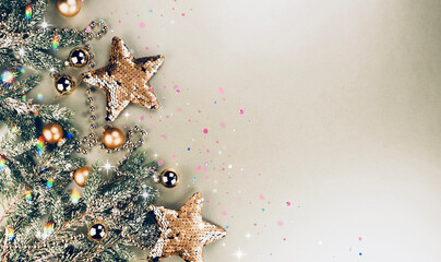 Poster - Christmas decorations concept. Gold stars and balls and fir branches on a golden background. Greeting card mockup, New Year banner template.