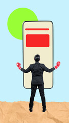 Canvas Print - Rear view of a businessman with a red boxing glove looking at the mobile phone screen