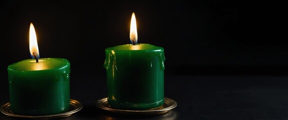 Sticker - a green candle on plain black background for banner with copy space