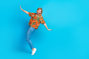 Canvas Print - Photo of worried lovely girl wear stylish orange print clothes look down precipice blank space isolated on blue color background