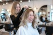 © SC Media - woman in the hairdresser salon gets a new styled haircut, sitting on the chair and talks to the hairstylist. smiling and looking happy as she sits