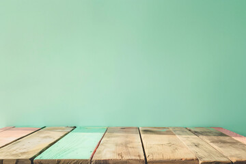 Poster - Empty light brown wood table top on pastel green background for product display montage, space photography