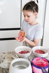 Wall Mural - Young Chef Prepares Chocolate-Covered Treats in Sunny Kitchen