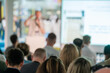 © Anton Gvozdikov - Group of people attentively listening to a speaker at a business seminar or presentation. The speaker is in focus while giving a talk.