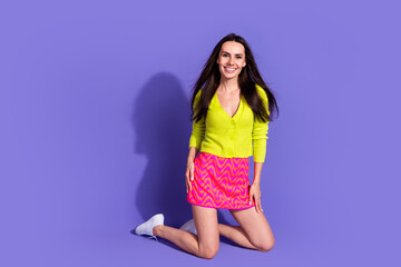 Sticker - Photo of gorgeous lovely girl wear trendy bright clothes sitting posing floor isolated on purple color background