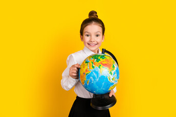 Poster - Photo of cute schoolgirl wear uniform isolated on yellow color background