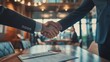 © Tetiana - A Firm Handshake Seals a Deal in a Modern Office