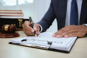 A lawyer in a professional office provides legal advice and services, handles documents, agreements, contracts, and represents clients in court.