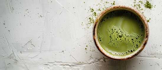 Aufkleber - Bird s eye view of a cup filled with matcha green tea on a blank white surface with space for text or other elements creating a copy space image