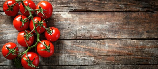 Fresh tomatoes arranged on a rustic wooden table with ample copy space image