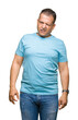 © Krakenimages.com - Middle age arab man wearing blue t-shirt over isolated background winking looking at the camera with sexy expression, cheerful and happy face.
