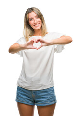 Poster - Young beautiful woman over isolated background smiling in love showing heart symbol and shape with hands. Romantic concept.