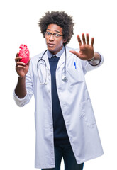 Canvas Print - Afro american cardiologist doctor man over isolated background with open hand doing stop sign with serious and confident expression, defense gesture