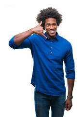 Sticker - Afro american man over isolated background smiling doing phone gesture with hand and fingers like talking on the telephone. Communicating concepts.