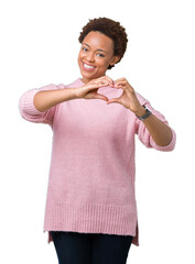 Sticker - Beautiful young african american woman over isolated background smiling in love showing heart symbol and shape with hands. Romantic concept.