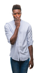 Sticker - Young african american man over isolated background bored yawning tired covering mouth with hand. Restless and sleepiness.