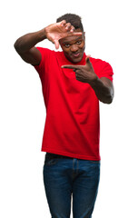 Sticker - Young african american man over isolated background smiling making frame with hands and fingers with happy face. Creativity and photography concept.