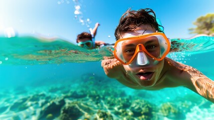 A male snorkeler in vibrant, clear blue waters explores marine life while wearing an orange snorkel mask. The image captures the essence of underwater adventure and exploration.