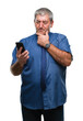 © Krakenimages.com - Handsome senior man texting sending message using smartphone over isolated background serious face thinking about question, very confused idea
