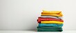 © vxnaghiyev - Colorful clothes stack on white table with empty copy space image