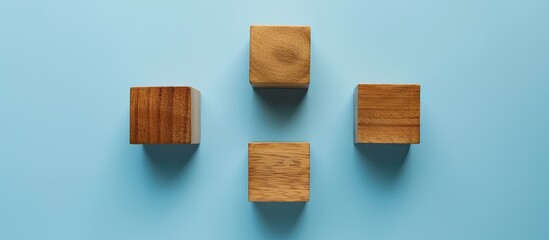 Poster - A bird s eye view of three empty wooden cubes on a blue backdrop with copy space image