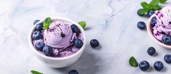 Poster - Delicious dairy free blueberry ice cream dessert topped with fresh organic blueberries and mint ideal for a healthy vegetarian or vegan diet with copy space image