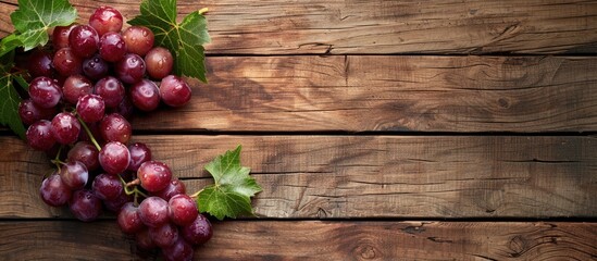 Poster - Grape placed on a wooden table with copy space image available