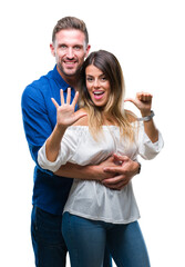 Poster - Young couple in love over isolated background showing and pointing up with fingers number six while smiling confident and happy.